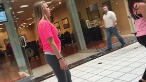 Little blonde teen in grey leggings at the mall with her friends