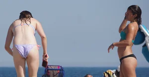 2 cute friends in bikinis on the beach