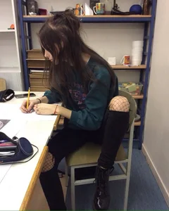 Girl Sitting in Black Torn Jeans with Fishnet Pantyhose Underneath with Spread Legs