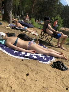 Girl in Swimsuit Lying on the Beach on Her Stomach