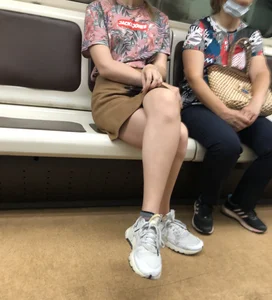 Amazing Hot Girl in a Skirt and Sneakers Sitting Cross-Legged in the Subway Train and on the Escalator Candid Photos Gallery