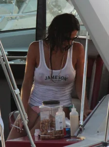 Bikini babe on a boat with a wet see through white shirt showing her tits