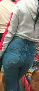 Skinny brunette with a nice booty in line in tight jeans