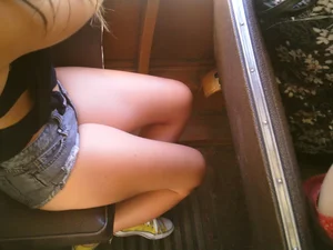 Sexy girl on the bus in jean shorts with nice legs and cleavage