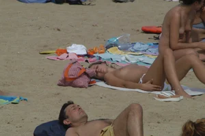 Topless girls on a beach in Barcelona