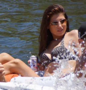 Sexy party girls in bikinis on a lake