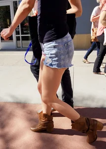 Cute girl with glasses in USA shorts showing her cheeks