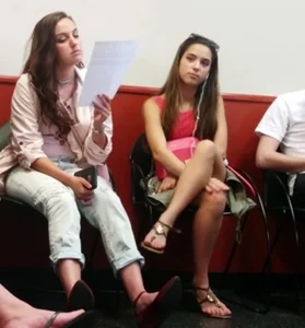 Cute Girl Sitting Crossed-Legged in Sandals Candid Photo