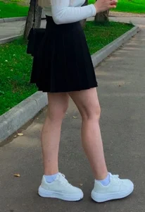 Teen girl's legs in a skirt street photos