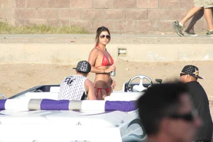 Brunette on a boat in red thong bikini with a tight little ass