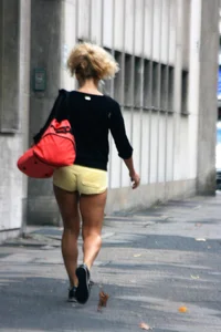 Blonde looking sexy walking in short yellow shorts