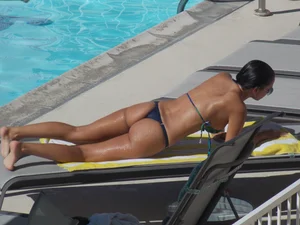 Hot milf sunbathing in a thong by pool and swimming