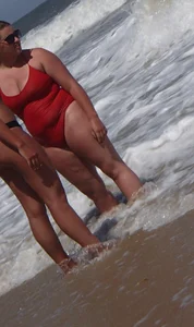Fat chick on the beach in a red swimsuit