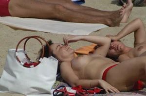 Topless girls on a beach in Barcelona