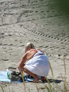 Mature blonde lady on a nude beach with big boobs