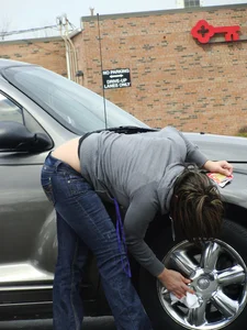 Girl cleaning her car in jeans and showing some cheetah print underwear