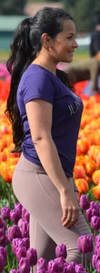 Cute babe in tight leggings taking pictures in flower fields