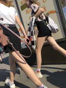 Couple of Skinny Girls in Mini-Skirts And Sneakers Street Photos