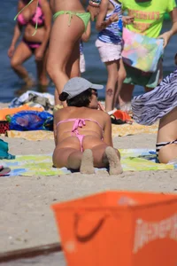 Sexy milf in pink thong bikini on the beach
