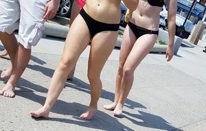 Cute brunette looking sexy in black bikini with friends