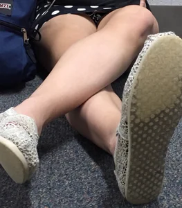 Girl in a Dress Sitting on the Floor With Crossed Legs