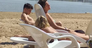 Blonde beach girl with a great ass in pink thong bikini