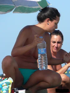 Bunch of sexy babes on the beach topless and in thong bikinis