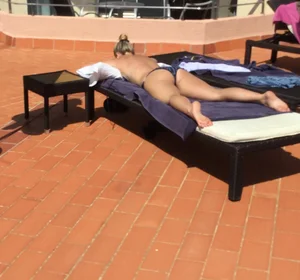 Blonde laying out in a blue bikini with a sexy body