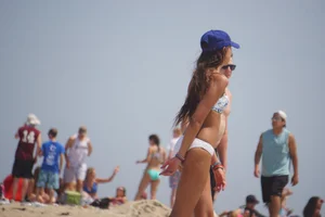 Beach football sexy brunette in white bikini