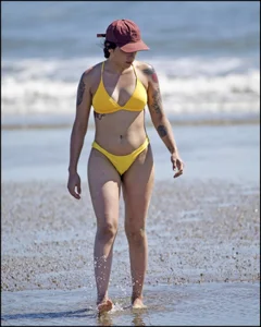 Sexy tattooed beach brunette with a great ass in yellow thong bikini