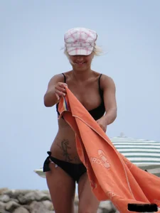 Tattooed blonde with big tits topless and in thong