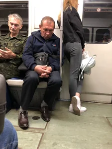 Skinny teen wearing tight grey jeans in a subway train