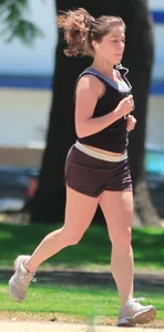 Cute girl running in short shorts