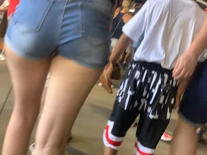 Bunch of girls in various outfits at a Cardinals baseball game
