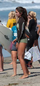 Hot Asian teen surfer at the beach in little shorts showing her bikini vpl underneath