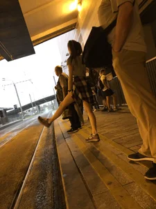 Cute Teen in Shorts on the Tram Stop