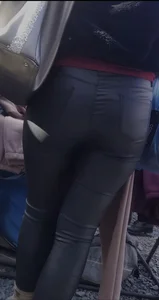 Milf shows off her shapely ass in her leather pants at the market