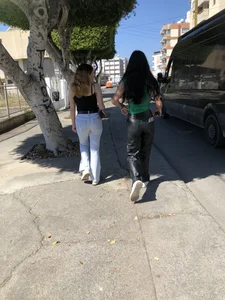 Two hot gals, one in tight jeans, another in leather pants