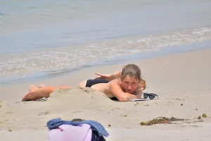 Sexy chick in red and black bikini on the beach