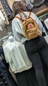 Beautiful shape booty brunette hair Girl in black legging at clothing shop