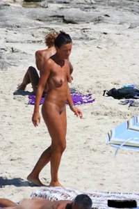 Smoking milf at a nude beach with a hairy pussy