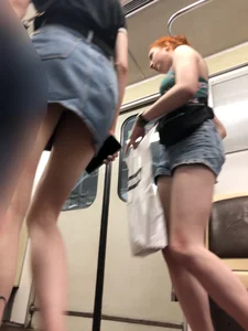 Two Girls With Hot Long Legs in Mini Shorts and Sneakers in the Subway Train Candid Photo Gallery