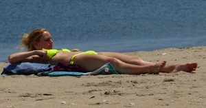 Sexy ass blonde milf on the beach in a thong with cameltoe and bending over