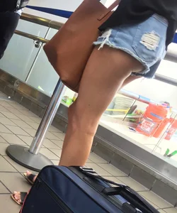 Sexy brunette waiting in line with short jean shorts