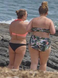 Thick and sexy bikini babe in black and peach bikini outfit