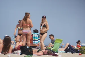 Two thick white girls in bikinis on the beach with big asses