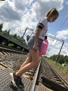 Cute Girl in Denim Shorts Walking Down a Railway Station Gallery