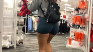 Latina squatting in spandex shorts