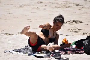 Beach girl can't keep her tits in her bikini