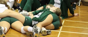 Girls in Sports Uniforms Lying on the Gymnasium Floor Candid Photo